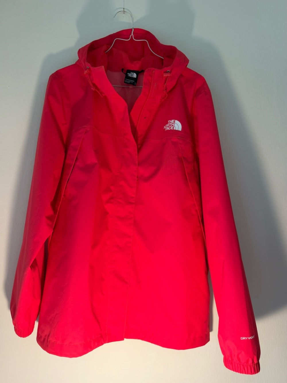 The North Face Women's Bright Pink Hooded Rain jacket.